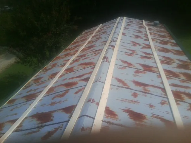 Rusted metal roof panels with new wood purlins before replacement — Storm Damage Roof Repair in Fort Mitchell by Roofing Brothers