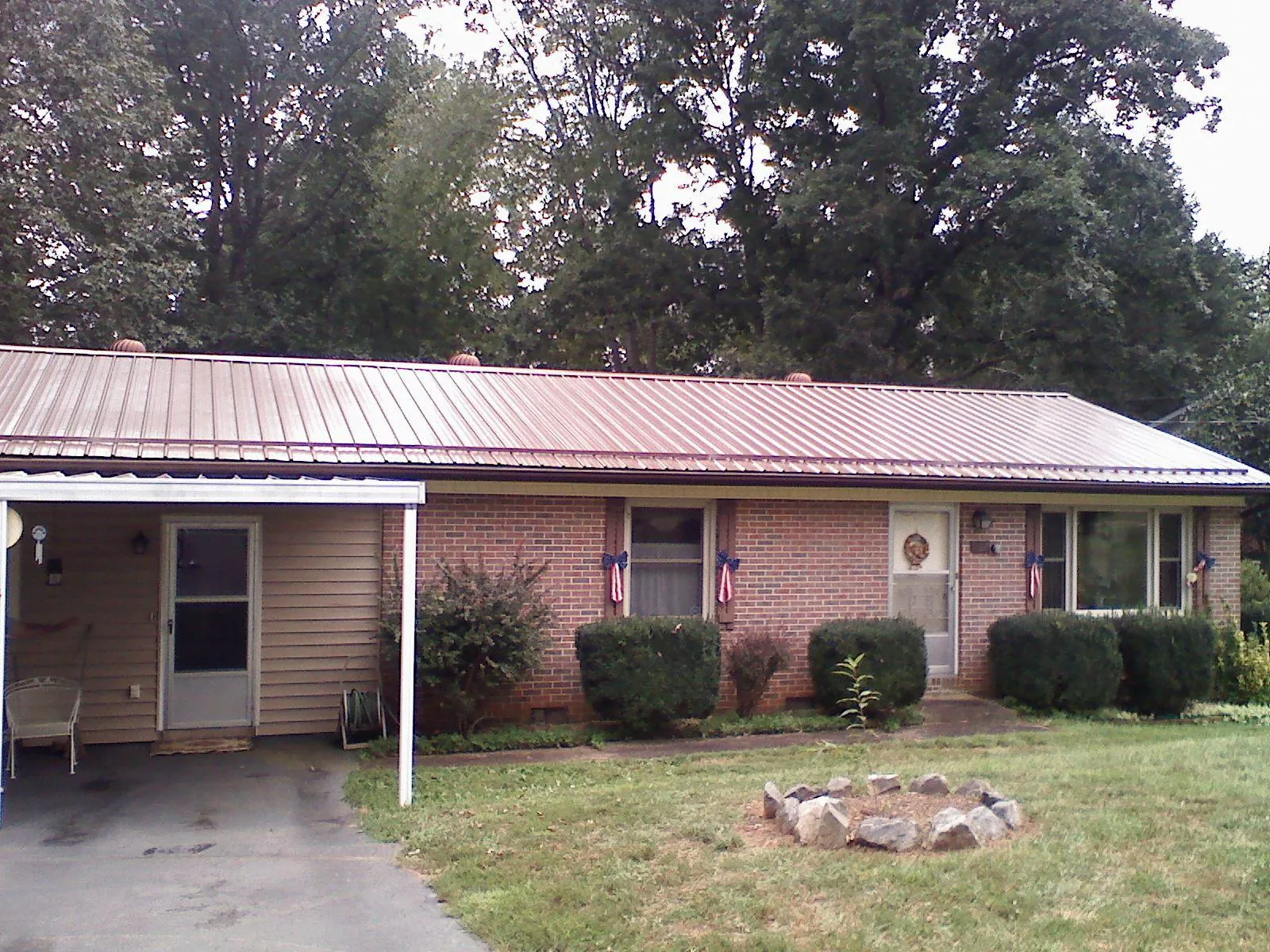 Bronze metal roof and carport on a brick ranch home — Roof Repair work by our crew in Fort Mitchell