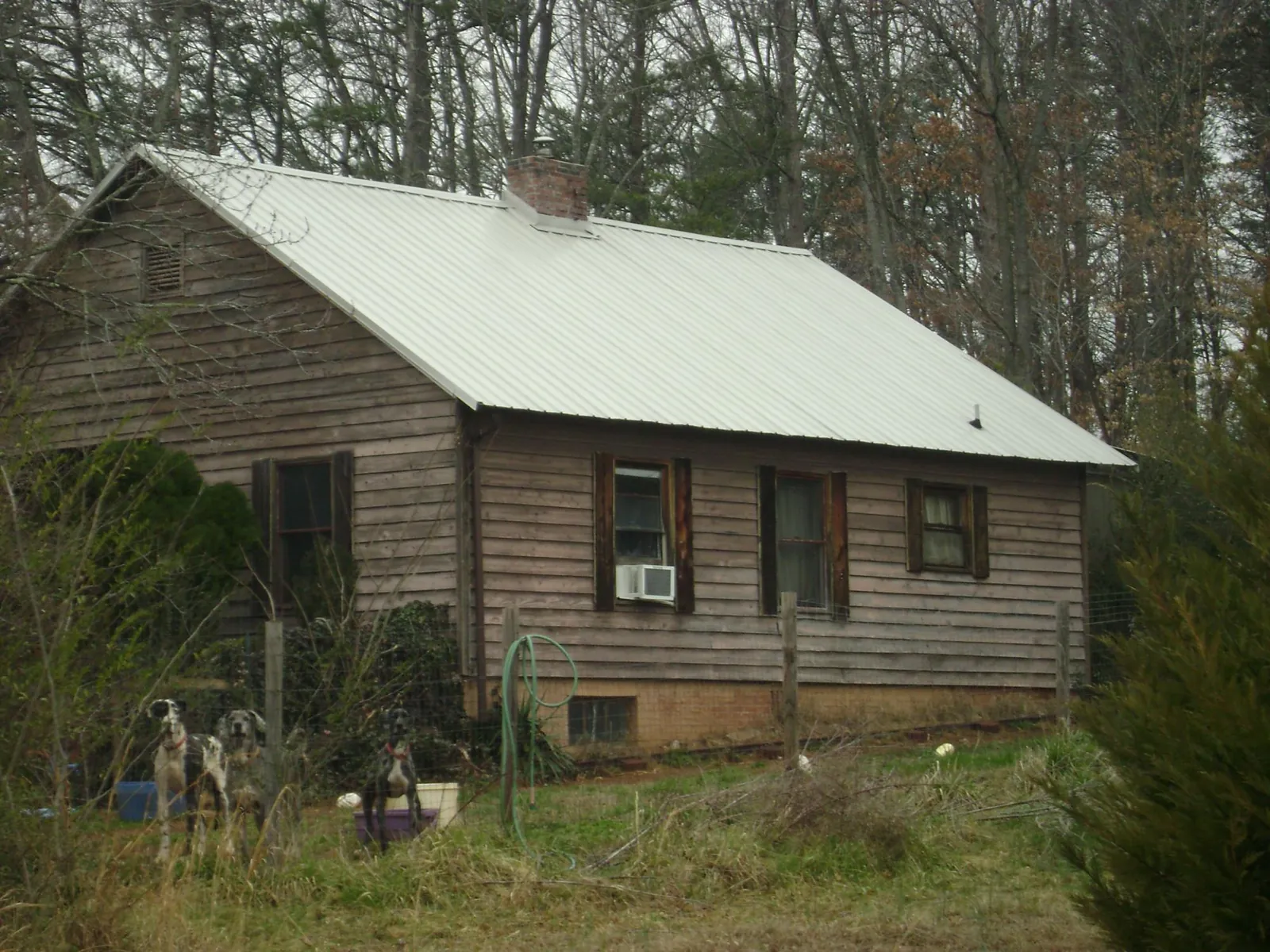 White metal roof on an old wood sided farmhouse, from a Metal Roof Installation job in Fort Mitchell